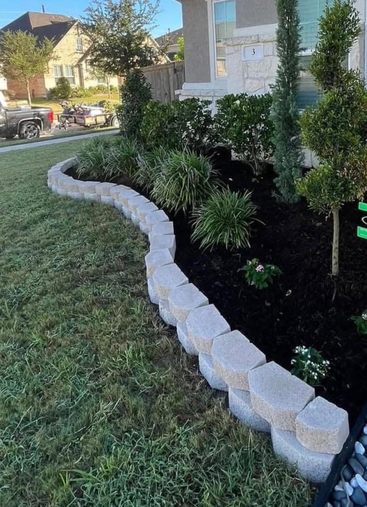 Custom curved stone edging and fresh mulch beds by Arvo Landscapes, Cypress TX