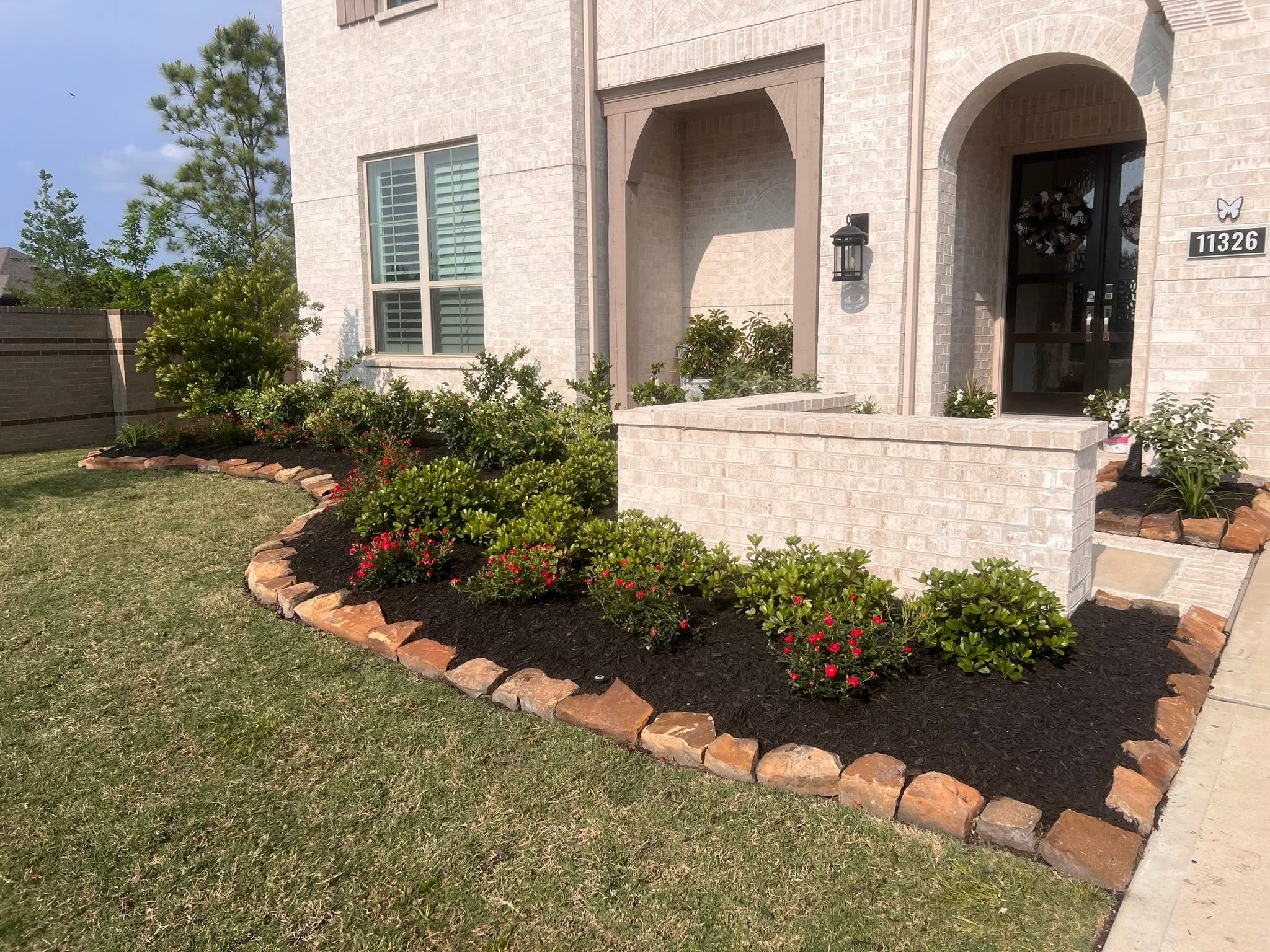 Finished front-yard flower bed and landscaping by Arvo Landscapes in Cypress, TX