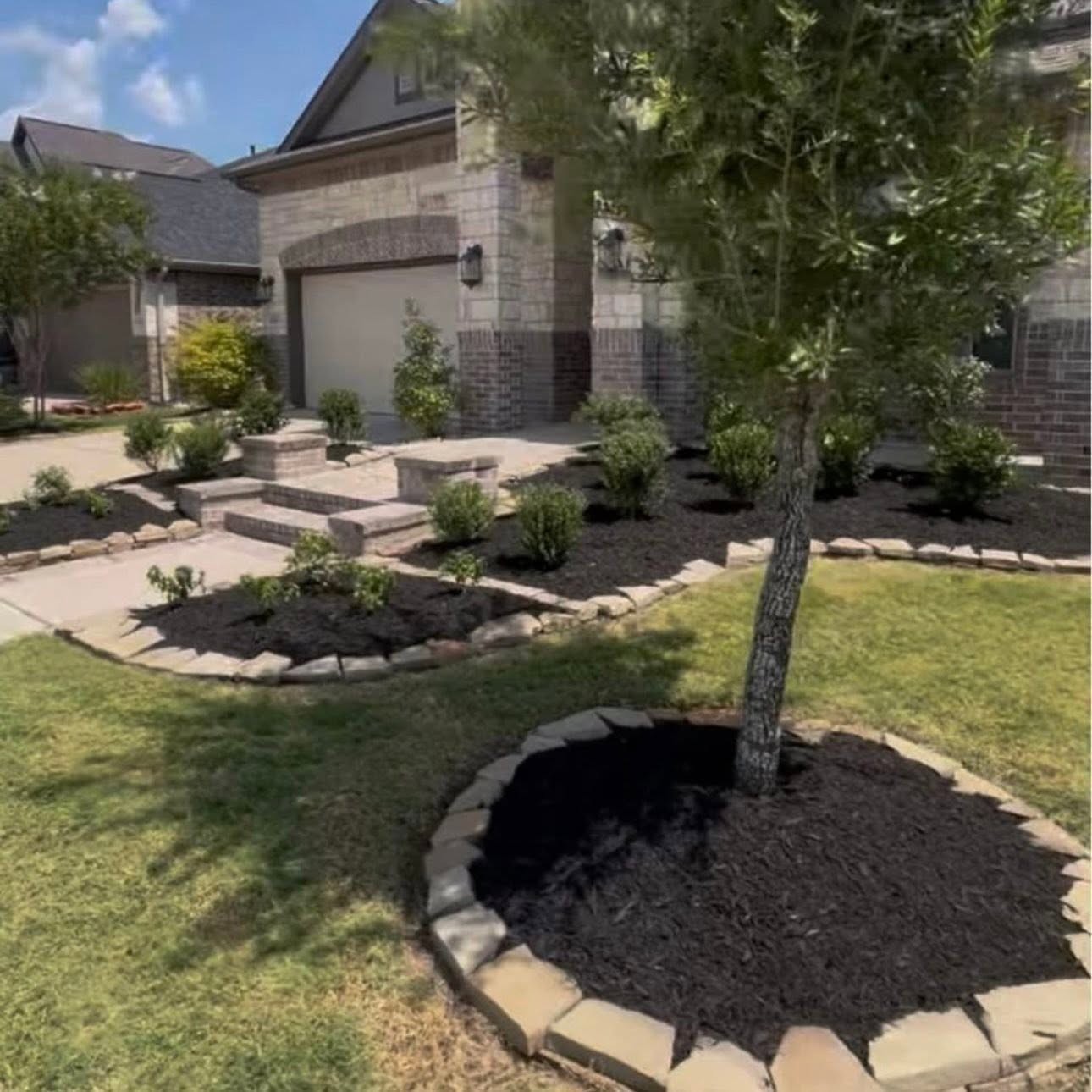 Tree mulch ring with stone edging by Arvo Landscapes, Cypress TX